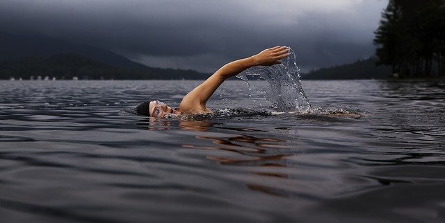 person swimming in a loch