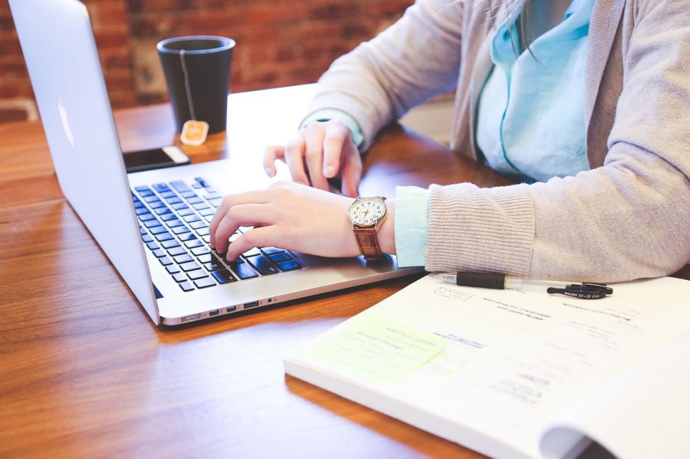 person typing on keyboard