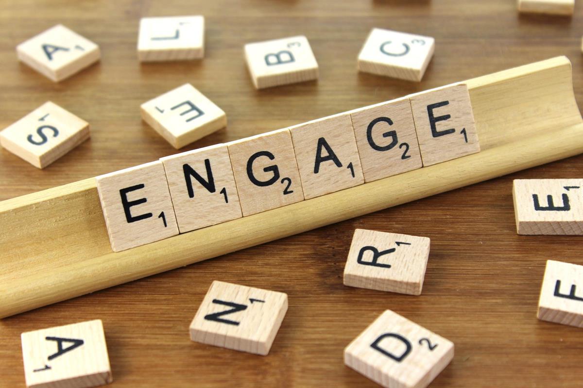 the word 'engage' spelled out with scrabble counters
