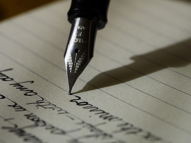 close up of pen nib on writing paper