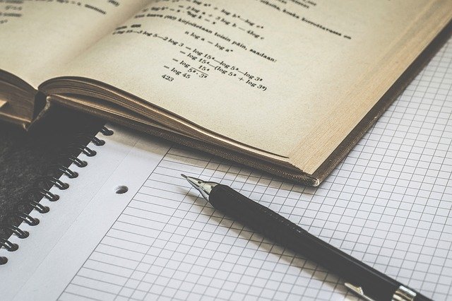 decorative image of a math book, a notebook and a pen